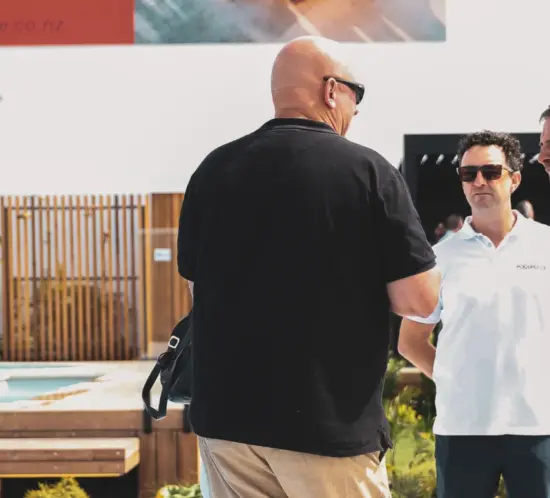 Man telling his friends about the great experience he had building a pool with The PoolHouse.